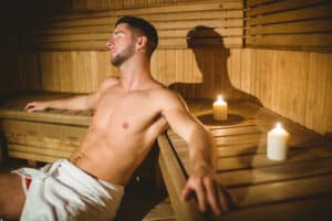Man sitting inside a sauna at the spa